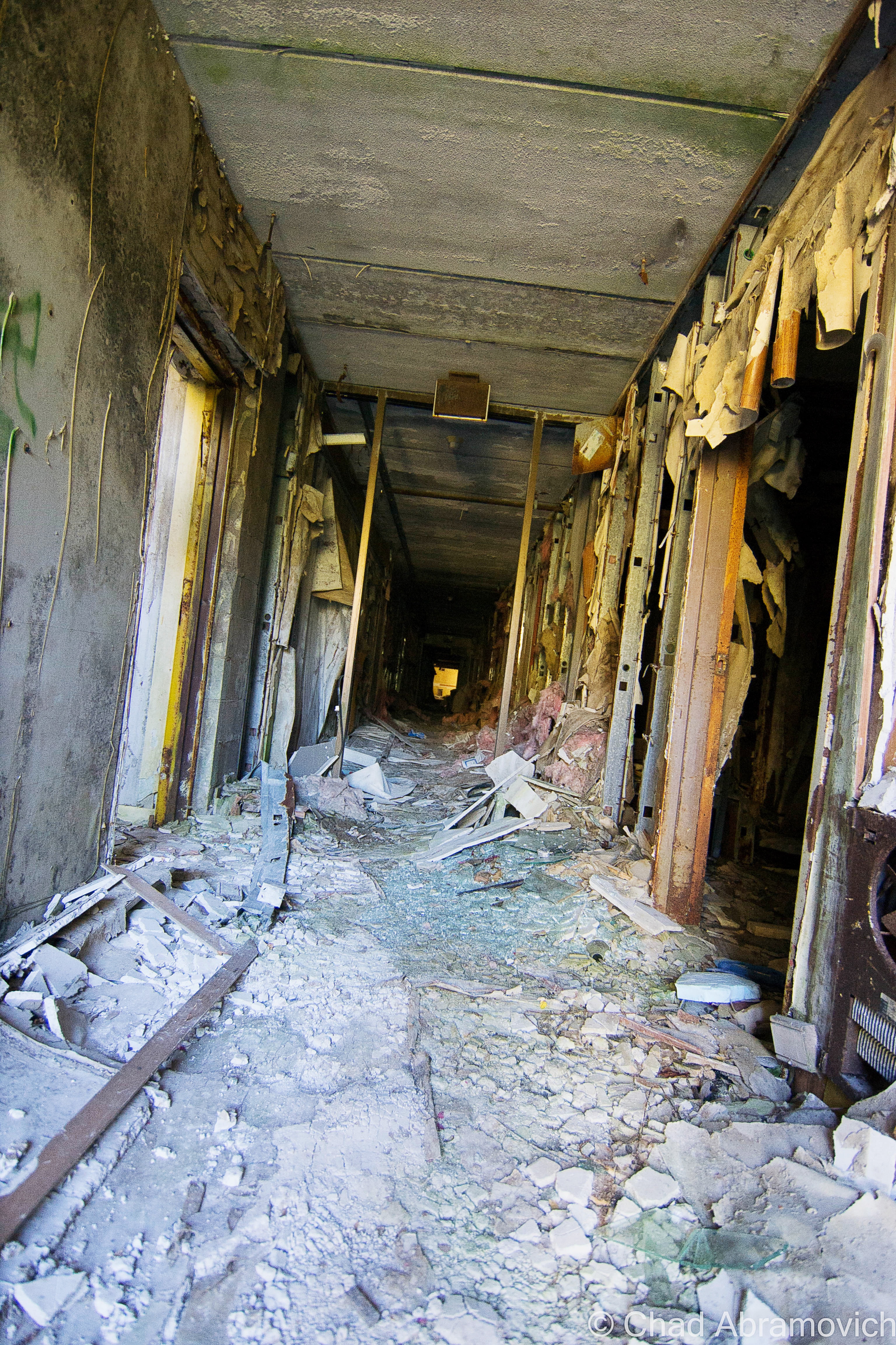 The eeriness of the property was unshakable as I walked around. The ugly and dated buildings were reduced to indignant and unsettling billboards that reckless destruction wrote. A fetid stench was the first thing I noticed long before I tromped under the coolness of the building shadows, a stagnant foul entity that permeated around the entire property. 