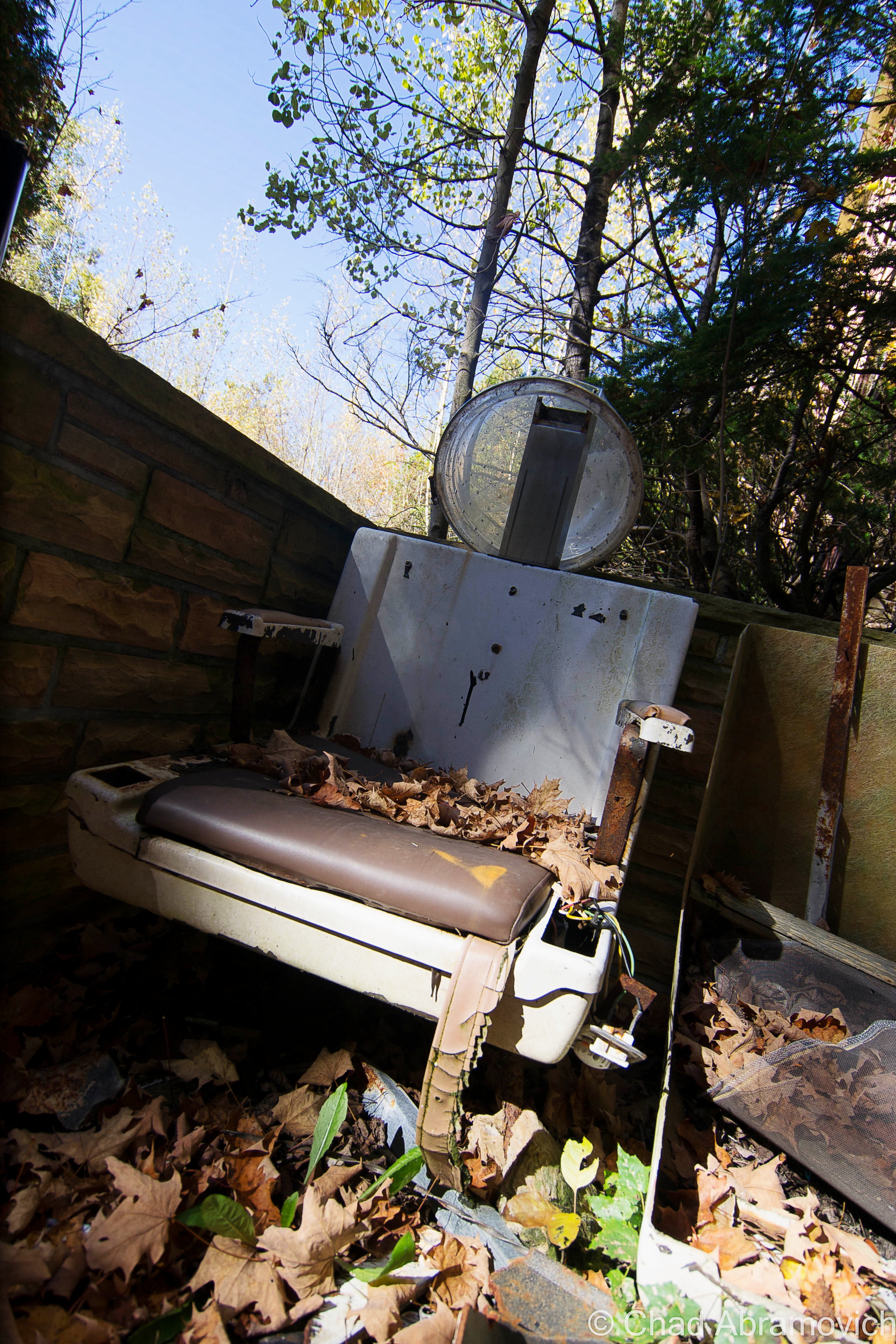 An old beauty salon chair, located down in dank and dark levels below, seemed to have been dragged outside and left out near the bar.