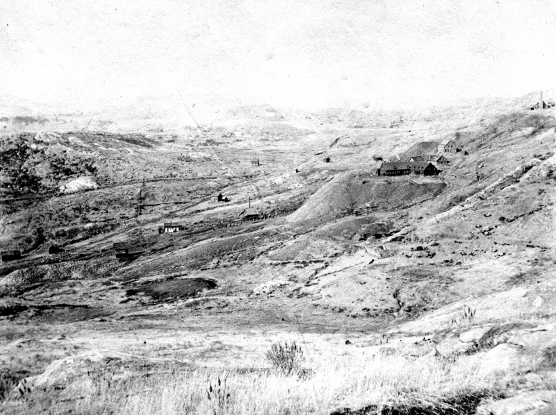 A view of the Ely mine, Copperfield and West Hill taken around 1900, after the mine's abandonment. The landscape is a barren and desolate one, devoid of vegetation. | UVM Landscape Change Program