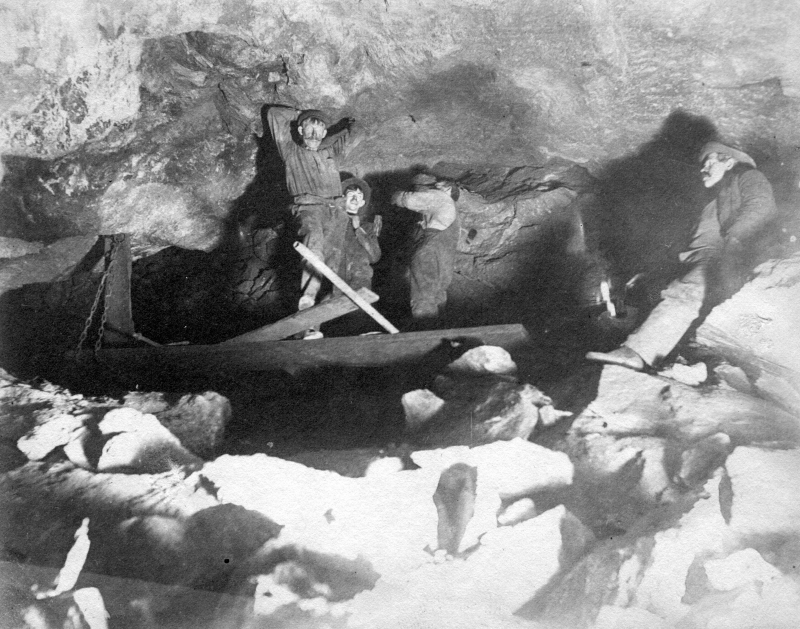 A group of men deep down in what they called "The Back Stopes", or the deepest section of the Ely mine, which was supported by steel L-beams and more loose rocks that fell from the shaft walls. Gotta make use of all those rocks I suppose. | UVM Landscape Change Program